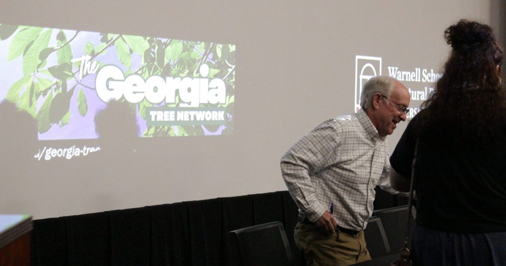 Doug Tallamy in front of the Georgia Tree Network logo.